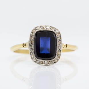 Antique Art Deco 18K gold and Platinum Diamond Ring: This original Art Deco ring was handmade in 18k gold and platinum during the 1920´s. One cushion cut synthetic sapphire that weighs 3ctw approx. radiates from the center of this lovely piece. The