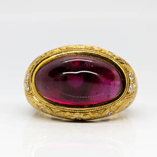 Antique 18K Gold Rubellite and Diamond Ring: This exquisite ring features one center sugarloaf rubellite of intense red color that weighs 9.39ctw. Handmade in 18k gold, this piece of jewelry also displays old European cut diamonds that weigh