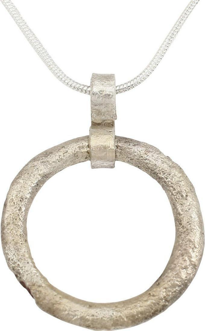 VIKING PROTECTIVE BROOCH NECKLACE 10th C.AD: Circular bronze, just under 1” diameter. Rounded face angled to form ridged edged in and out. The surface with texture from burial. Professionally conserved and the silver surface restored. On a