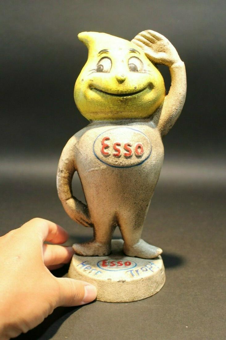 Cast Iron Esso Coin Bank M Busch Gmbh: 9 1/4" Tall x 5" wide Wonderful cast iron reproduction antique Esso man coin bank doll. As you can see this coin bank looks like an original! See the images for the best details. Such a neat collectib