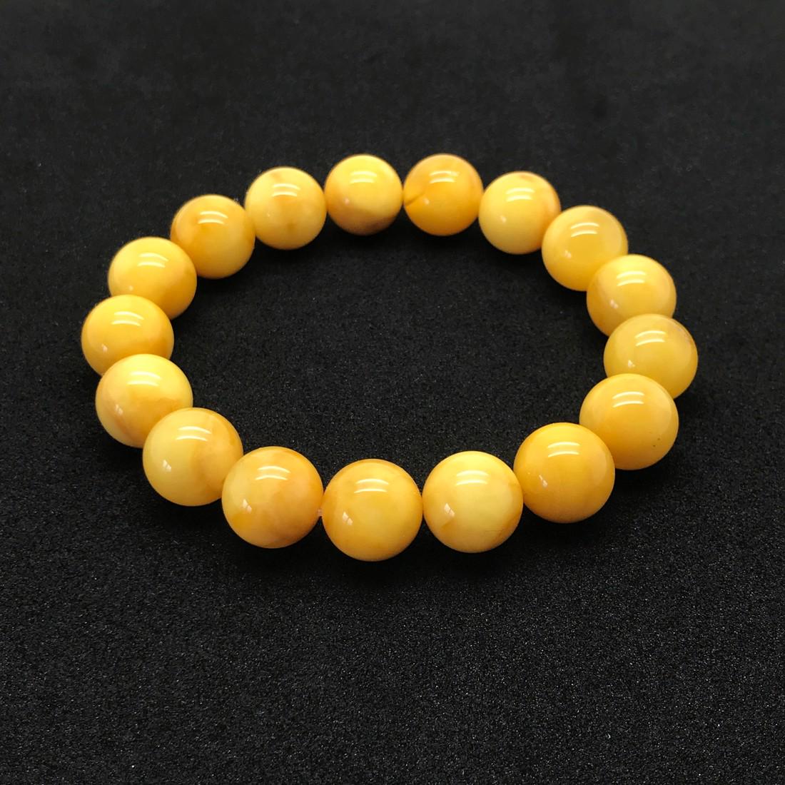 Astonishing Amber Bracelet made from Round Amber beads: Title: Astonishing Amber Bracelet made from Round Amber beads Metal: None Gemstones: Amber Weight: 15.7 g Size: Bead size: 12.0 mm Bead size: 0.472 inches Made of: Whole Stone Additional Information: 