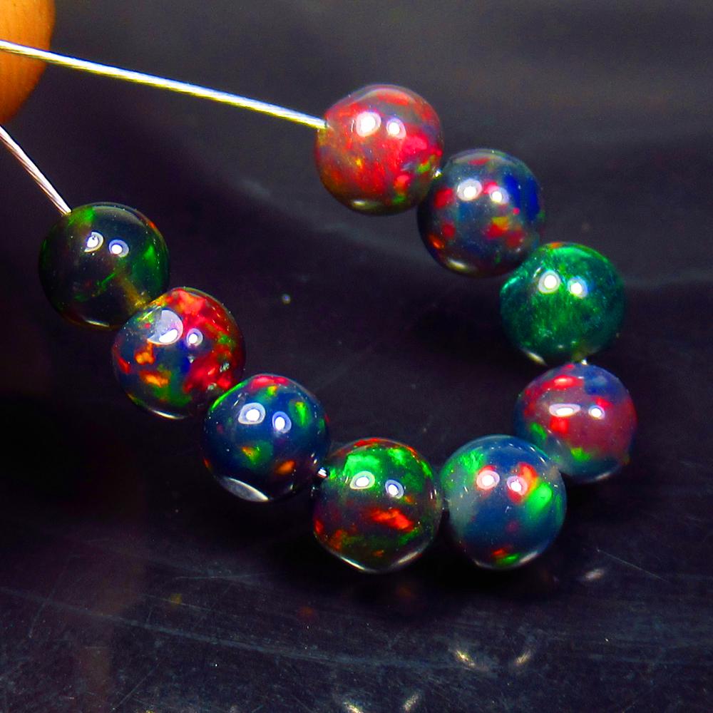 3.21 Ctw Natural 9 Drilled Black Fire Opal Ball Beads: No Reserve! Title: 3.21 Ctw Natural 9 Drilled Black Fire Opal Ball Beads Stone Clarity: Translucent Gemstones: Black Opal Beads Carat Weights: 3.21 Size/Dimensions: 4.10 to 4.60 mm / 9 PC's Additional
