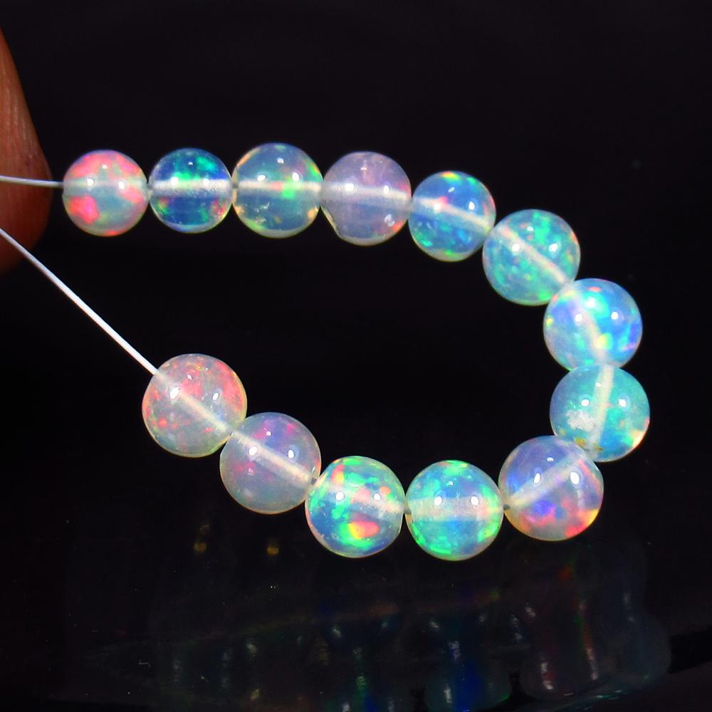 7.03 Ctw Natural 13 Drilled Multi-Color Fire Opal Ball: Title: 7.03 Ctw Natural 13 Drilled Multi-Color Fire Opal Ball beads Stone Clarity: Transparent Gemstones: Opal Beads Carat Weights: 7.03 Size/Dimensions: 5.00 - 5.20 mm/ 13 PC's Additional Information