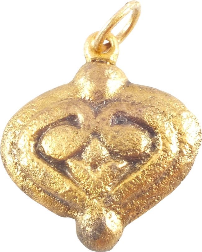 VIKING HEART PENDANT, C. 850-1050 AD: Gilt bronze. Just under 7/8" height. Domed form with raised heart, the cusp terminals evolving into the upper part of the enclosed trefoil. Made by the open face mold technique. The heart stood for br