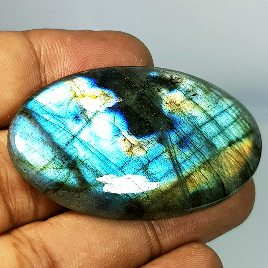 70.05 Ct Natural Labradorite: No Reserve! Title: 70.05 Ct Natural Labradorite Color/Clarity: Opaque Gemstones: LooseGemstone Carat Weights: 70.05 Size/Dimensions: 50.00 x 28.65 x 5.80 Additional Information: Oval - USA Shipping: