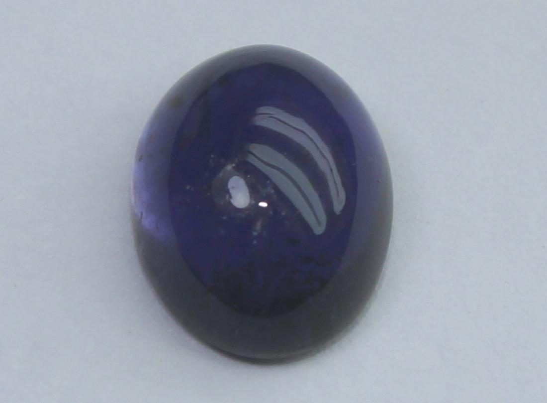 1.44 Cts Natural Iolite: No Reserve! Gemstone: Natural Iolite Origin: India Weight: 1.44 Carats Measurements: 8.4x6.3x3.8 mm Shape / Cut: Oval Cabochon Colour: Violet Blue Transparency: transparent Clarity: Some Natural inclu