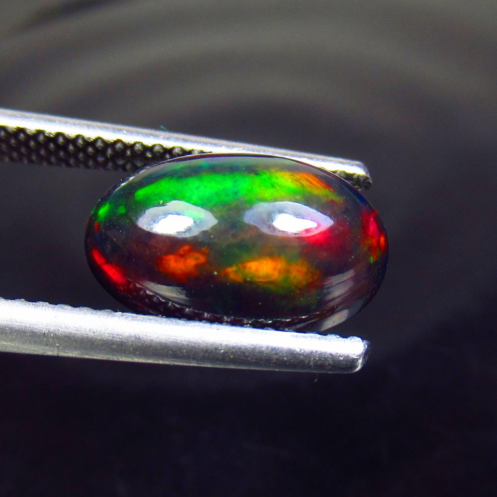2.54 Ctw Natural Ethiopian Black Fire Opal Oval Cab: No Reserve! Title: 2.54 Ctw Natural Ethiopian Black Fire Opal Oval Cab Stone Clarity: Translucent Gemstone: Black Opal Carat Weight: 2.54 Size/Dimensions: 12.80 x 7.90 x 4.80 mm Additional Information