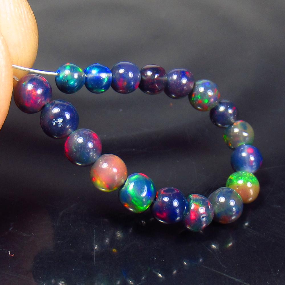 3.22 Ctw Natural 18 Drilled Black Fire Opal Ball Beads: No Reserve! Title: 3.22 Ctw Natural 18 Drilled Black Fire Opal Ball Beads Stone Clarity: Translucent Gemstone: Black Opal Beads Carat Weight: 3.22 Size/Dimensions: 3.10 to 3.90 mm / 18 PC's Additional