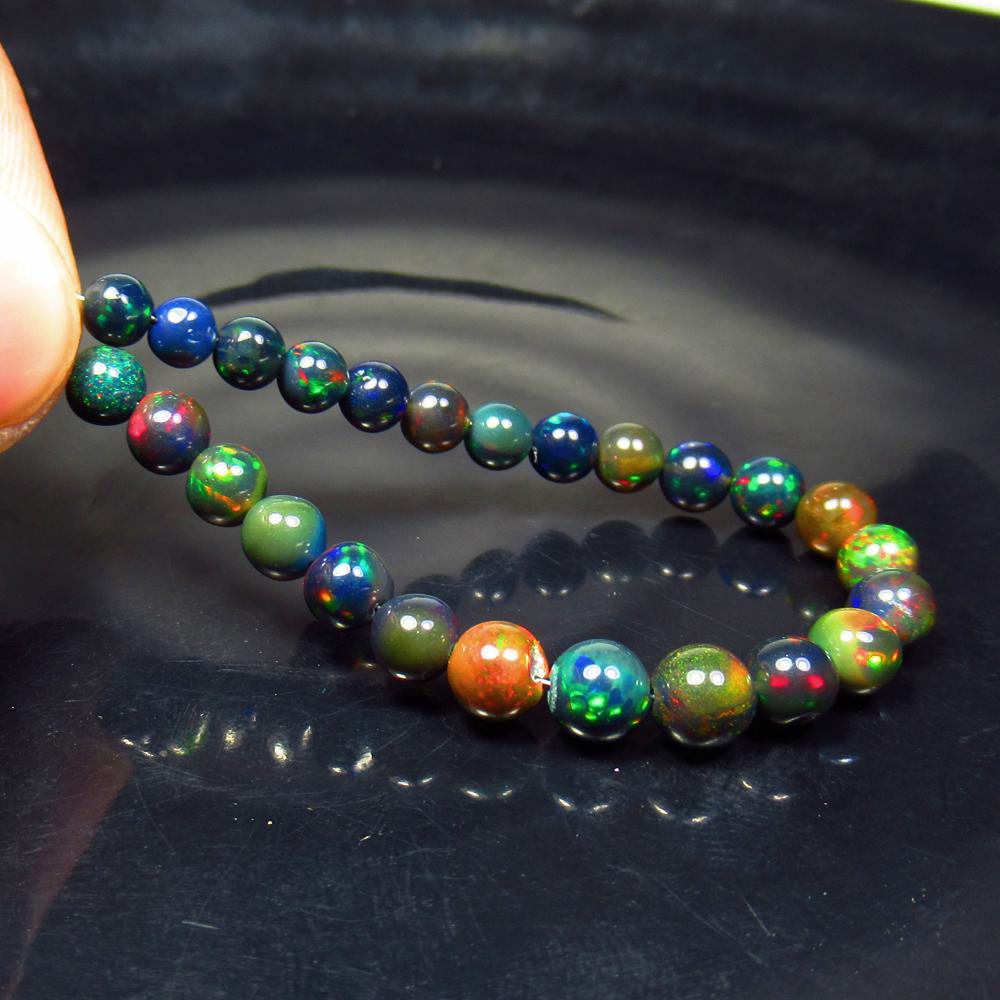 16.24 Ctw Natural 25 Drilled Black Opal Ball Beads: Title: 16.24 Ctw Natural 25 Drilled Black Opal Ball Beads Stone Clarity: Opaque Gemstones: Black Opal Beads Carat Weights: 16.24 Size/Dimensions: 4.80 to 5.50 mm / 25 PC's Additional Information: Dril