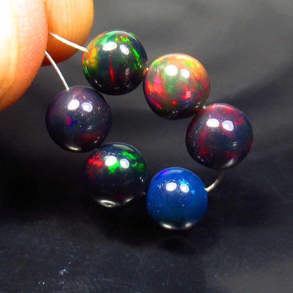 6.50 Ctw Natural 6 Drilled Black Fire Opal Ball Beads: Title: 6.50 Ctw Natural 6 Drilled Black Fire Opal Ball Beads Stone Clarity: Translucent Gemstones: Black Opal Beads Carat Weights: 6.5 Size/Dimensions: 6.30 to 6.60 mm / 6 PC's Additional Information: