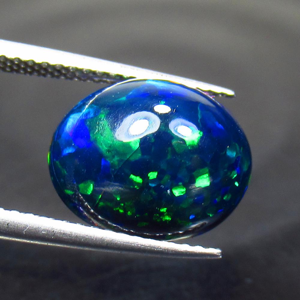 3.72 Ctw Natural Ethiopian Black Fire Opal Oval Cab: Title: 3.72 Ctw Natural Ethiopian Black Fire Opal Oval Cab Stone Clarity: Translucent Gemstones: Black Opal Carat Weights: 3.72 Size/Dimensions: 12.50 x 10.10 x 6.50 mm Additional Information: Excelle