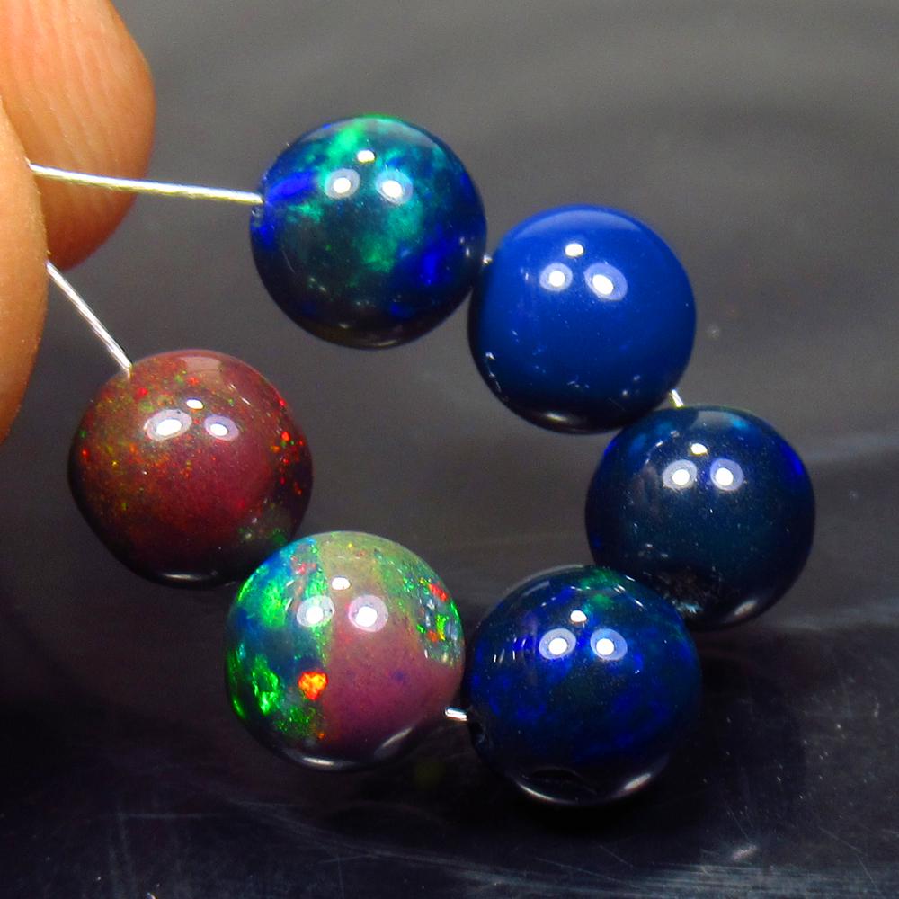 8.07 Ct Natural 6 Drilled Black Fire Opal Ball Beads: No Reserve! Title: 8.07 Ct Natural 6 Drilled Black Fire Opal Ball Beads Stone Clarity: Translucent Gemstone: Natural Black Opal Beads Carat Weight: 8.07 Size/Dimensions: 6.30 to 6.80 mm / 6 PC's Addit