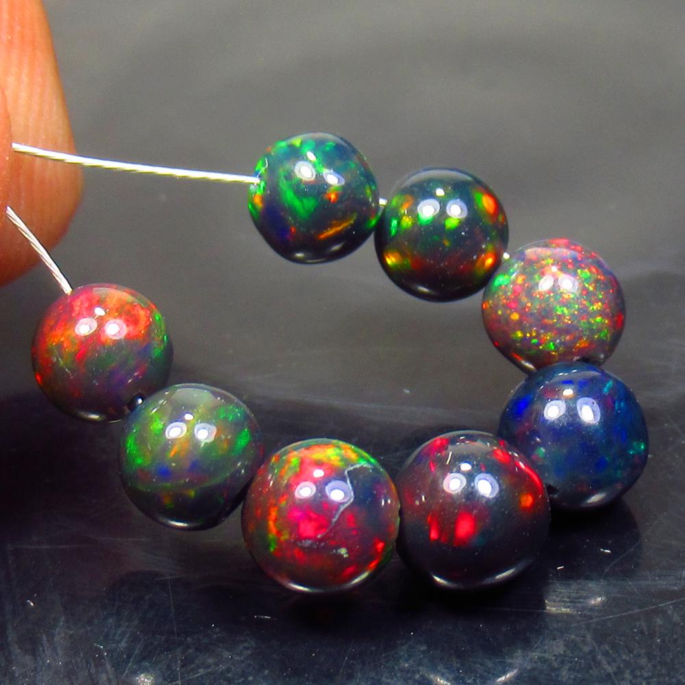 6.14 Ct Natural 8 Drilled Black Fire Opal Ball Beads: No Reserve! Title: 6.14 Ct Natural 8 Drilled Black Fire Opal Ball Beads Stone Clarity: Translucent Gemstone: Natural Black Opal Beads Carat Weight: 6.14 Size/Dimensions: 5.20 to 6.00 mm / 8 PC's Addit