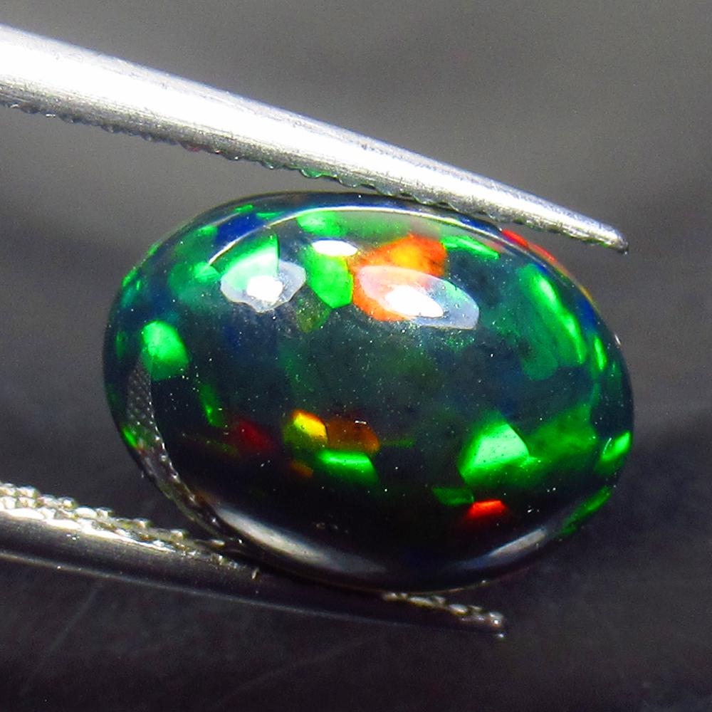 2.76 Ctw Natural Ethiopian Black Fire Opal Oval Cab: No Reserve! Title: 2.76 Ctw Natural Ethiopian Black Fire Opal Oval Cab Stone Clarity: Translucent Gemstone: Black Opal Carat Weight: 2.76 Size/Dimensions: 11.70 x 8.70 x 5.80 mm Additional Information