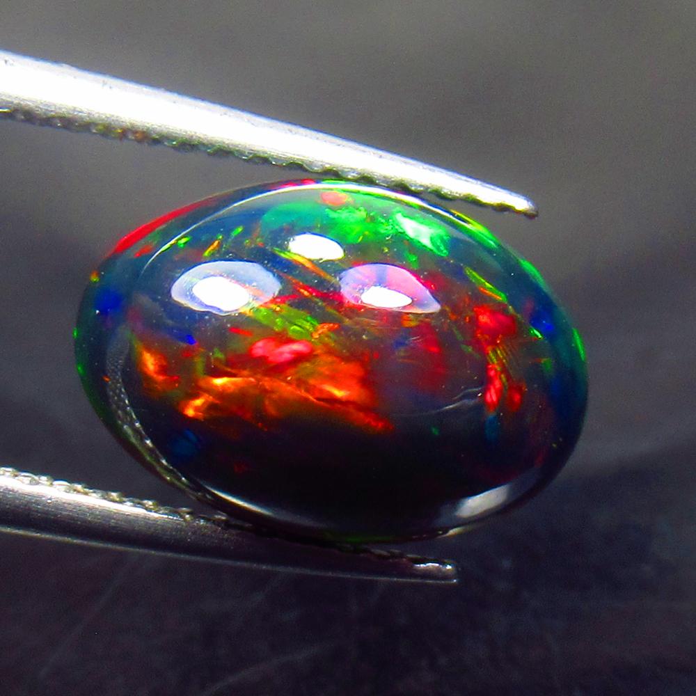 3.03 Ctw Natural Ethiopian Black Fire Opal Oval Cab: No Reserve! Title: 3.03 Ctw Natural Ethiopian Black Fire Opal Oval Cab Stone Clarity: Translucent Gemstone: Black Opal Carat Weight: 3.03 Size/Dimensions: 12.50 x 8.60 x 6.20 mm Additional Information