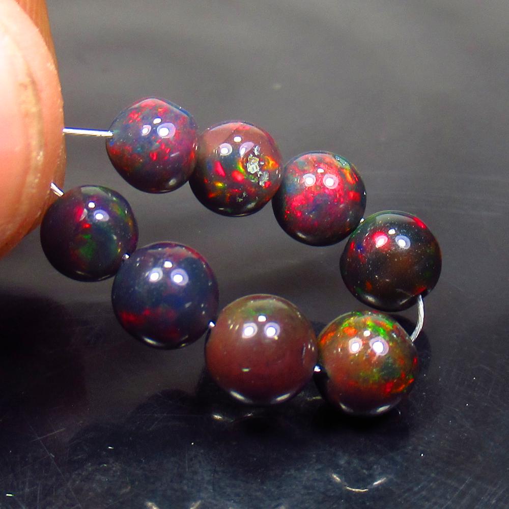 5.92 Ctw Natural 8 Drilled Black Fire Opal Ball Beads: No Reserve! Title: 5.92 Ctw Natural 8 Drilled Black Fire Opal Ball Beads Stone Clarity: Translucent Gemstone: Black Opal Beads Carat Weight: 5.92 Size/Dimensions: 5.10 to 5.90 mm / 8 PC's Additional I