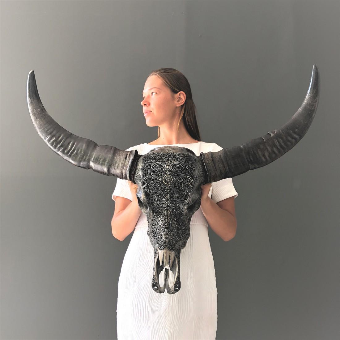 Authentic hand-carved grey water buffalo skull -: Title: Authentic hand-carved grey water buffalo skull - Traditional Balinese motif - Bubalus bubalis Maker: Design: Jake Richmond Origin: Indonesia Date/Period: 2020 Materials: Bone, Horn Dimensions:H