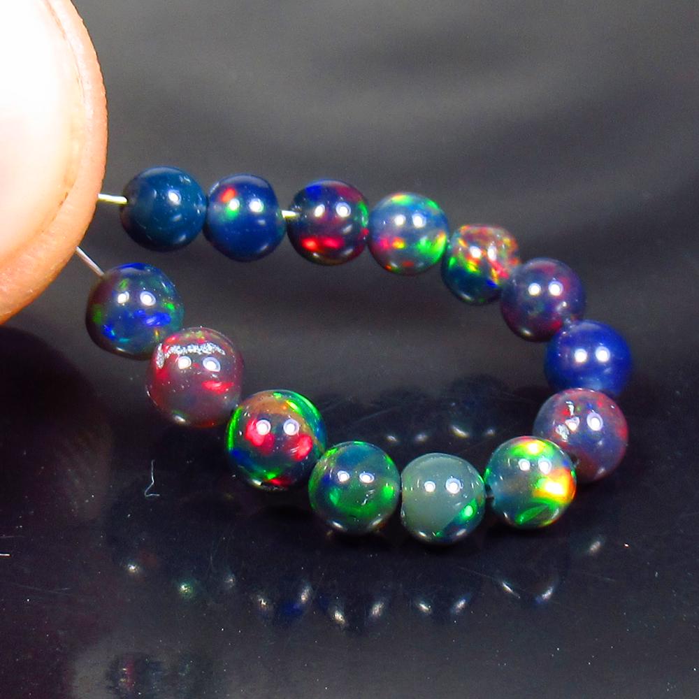 3.47 Ctw Natural 14 Drilled Black Fire Opal Ball Beads: No Reserve! Title: 3.47 Ctw Natural 14 Drilled Black Fire Opal Ball Beads Stone Clarity: Transparent Gemstones: Black Opal Beads Carat Weights: 3.47 Size/Dimensions: 3.70 - 4.20 mm / 14 Pcs Additional