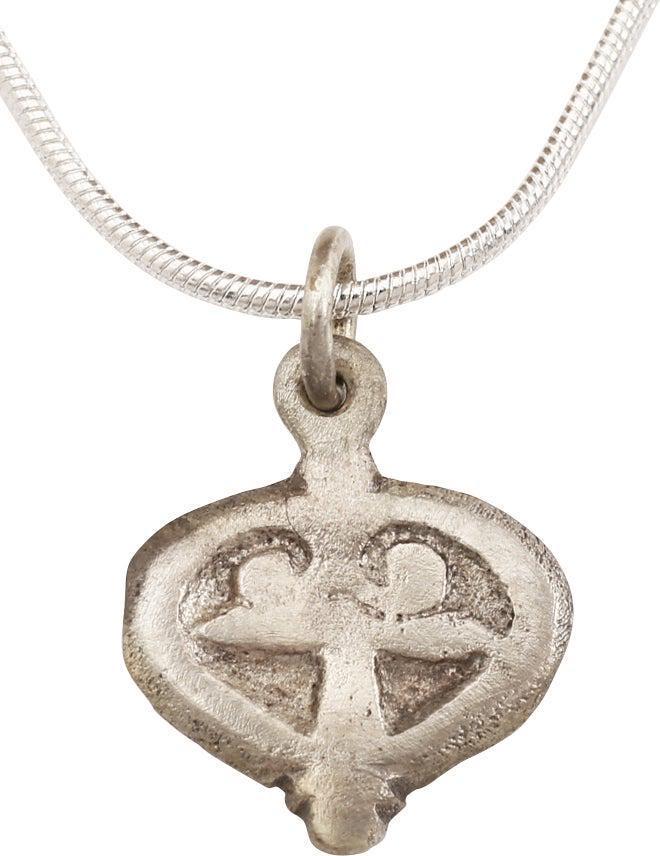 VIKING HEART PENDANT NECKLACE, C.900 AD: Early example of the fully evolved form. Raised border and triple trefoils to the field. The barely cusped top heart indicative of a transition from the naturalistic form which was used widely as well