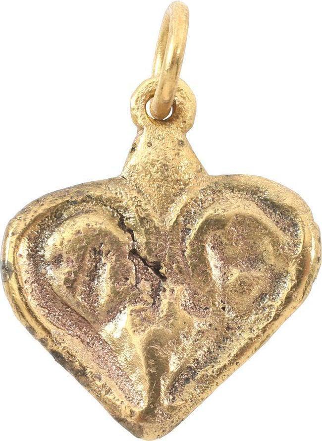 FINE VIKING HEART NECKLACE 9TH-10TH CENTURY AD: Gilt bronze. Just over 5/8” width with raised edge defining the fully evolved cusped top heart. The field with a well-delineated foliate trefoil in relief. The trefoil is a favorite theme for Vi