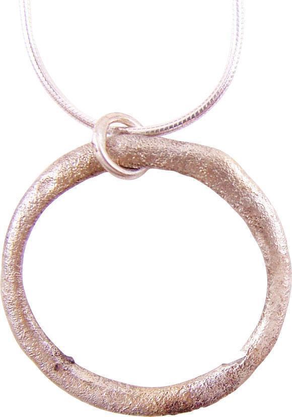 VIKING PROTECTIVE BROOCH NECKLACE 850-1000 AD JEWELRY: Silvered bronze, over 1 1/8" diameter. Circular with both sides rounded to an oval section. Worn in numbers on the surface of the jerkin, these small metal brooches provided a measure of protection ag