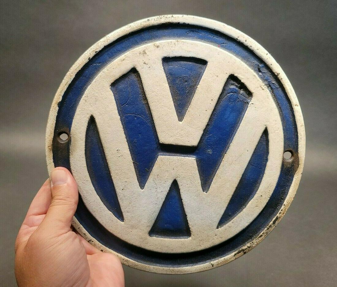 Cast Iron VW Volkswagen Sign Plaque: 9 1/8" Wide x 1/4" Thick Such a neat reproduction cast iron plaque/sign. This sign is all solid cast iron. Hand painted, wonderful signs of wear and distress. Hard to tell its age! Reserve: $45.00 Shi