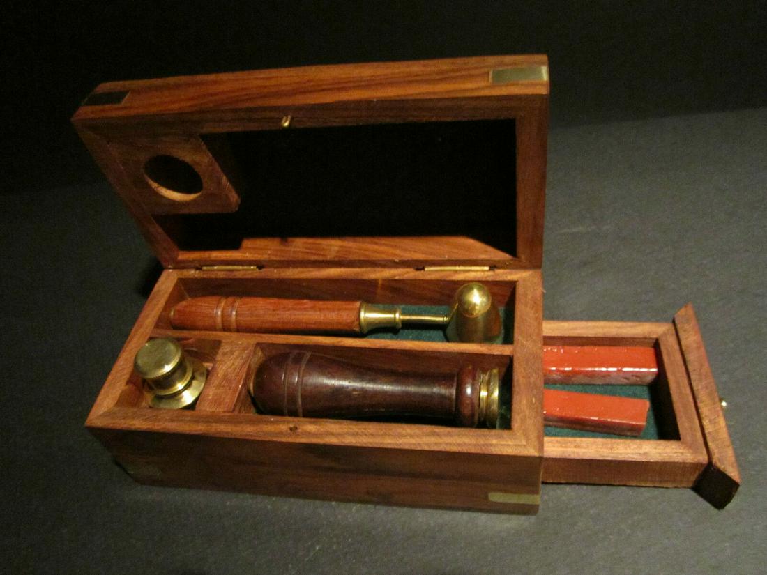 Letter Seal Wax Kit with Burner Spoon & Stamp: Description 5 1/2" Wide x 2 1/2" High x 2 3/4" Wide WAX SEAL KIT IN WOODEN BOX This reproduction of an antique wax seal kit has a solid brass burner, wax spoon with a wooden handle, a brass stamp with