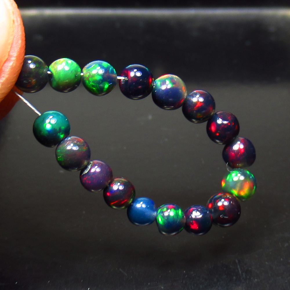 3.92 Ct Natural 17 Drilled Black Fire Opal Ball Beads: Title: 3.92 Ct Natural 17 Drilled Black Fire Opal Ball Beads Stone Clarity: Translucent Gemstone: Black Opal Beads Carat Weight: 3.92 Size/Dimensions: 3.20 to 4.10 mm / 17 PC's Additional Information: