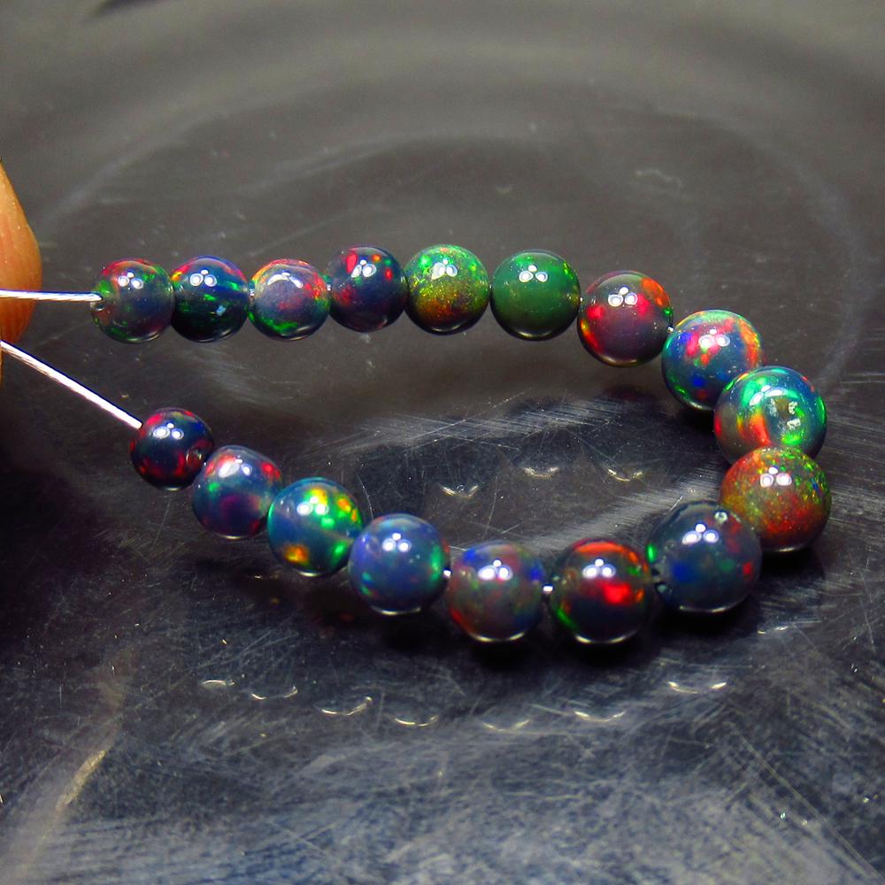 5.20 Ct Natural 17 Drilled Black Fire Opal Ball Beads: Title: 5.20 Ct Natural 17 Drilled Black Fire Opal Ball Beads Stone Clarity: Translucent Gemstone: Natural Black Opal Beads Carat Weight: 5.20 Size/Dimensions: 3.30 to 4.80 mm / 17 PC's Additional Info