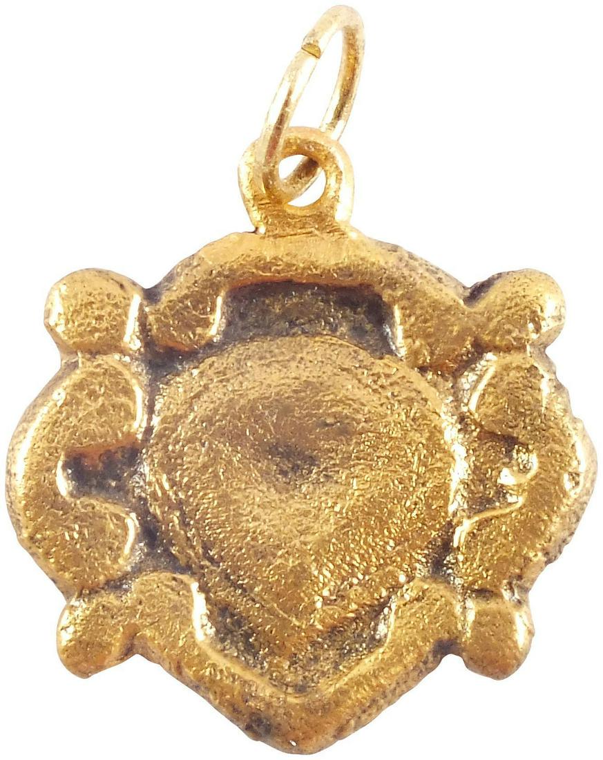 FINE VIKING HEART PENDANT, 10TH-11TH CENT AD: Just under 3/4" width. Centered heart of natural (uncusped) form with scrolling surround and quartered nubs. Made by the open face mold technique. The heart stood for bravery, fortitude, loyalty, inte