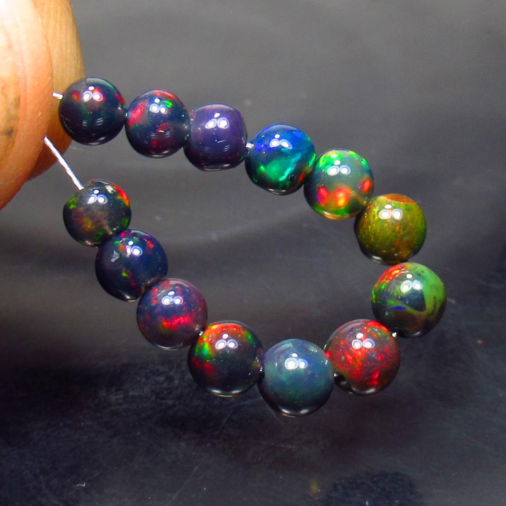 4.01 Ct Natural 13 Drilled Black Fire Opal Ball Beads: No Reserve! Title: 4.01 Ct Natural 13 Drilled Black Fire Opal Ball Beads Stone Clarity: Translucent Gemstone: Natural Black Opal Beads Carat Weight: 4.01 Dimensions: 3.80 to 4.40 mm / 13 PC's Addition