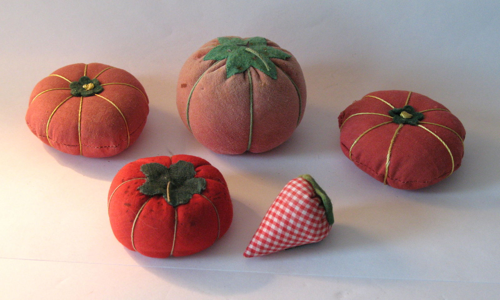 Group of five vintage tomato pincushions. (1 of 2)