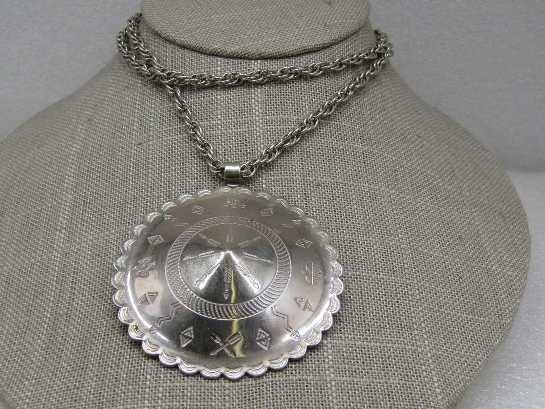 Vintage Southwestern Medalliion Necklace, 22",: Vintage Southwestern Medalliion Necklace, 22", 1970's-1980's. Silver tone with a 2.5" domed with center peak medallion, plus bail, stamped with Southwestern/Native American symbols. Scalloped and stam