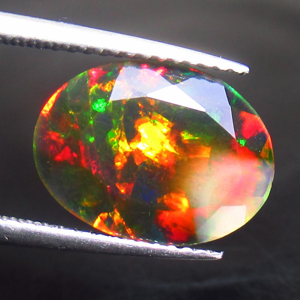 3.13 Ct Natural Black Fire Opal: Title: 3.13 Ct Natural Black Fire Opal Stone Clarity: Translucent Gemstones: Natural Opal Carat Weights: 3.13 Size/Dimensions: 13.50 x 9.80 x 5.70 mm Additional Information: Shape - Oval Cut / Color -