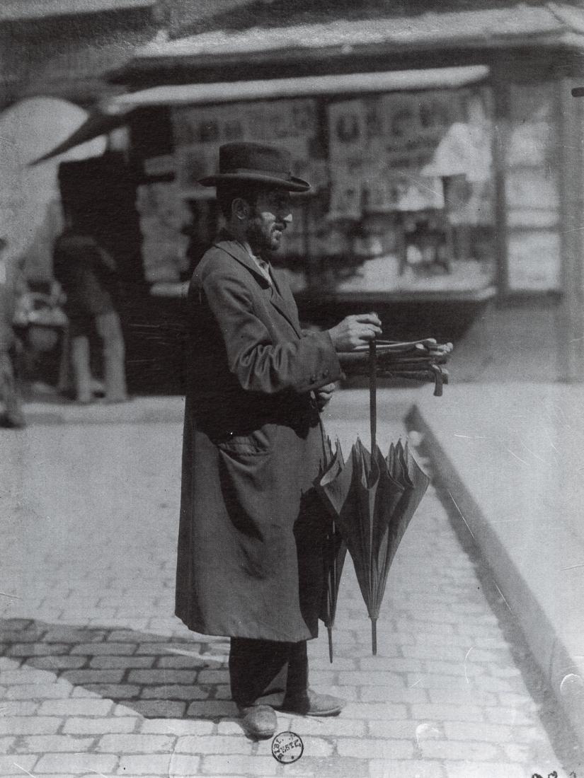 EUGENE ATGET - Umbrella Vendor, 1898: Artist: Eugene Atget Title: Umbrella Vendor, 1898 Medium: Duotone Photo Litho, 1988, Italy Dimensions: 6.55x8.75" Description: Heat Wax Mounted on 8.5x11" Conservation Board Artist Bio: Eugene Atget (