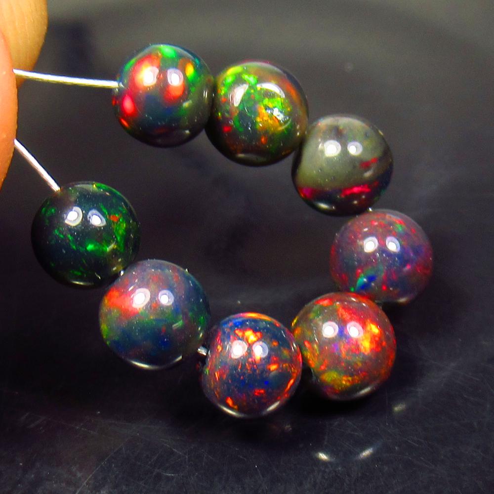 4.87 Ctw Natural 8 Drilled Black Fire Opal Ball Beads: No Reserve! Title: 4.87 Ctw Natural 8 Drilled Black Fire Opal Ball Beads Stone Clarity: Transparent Gemstones: Black Opal Beads Carat Weights: 4.87 Size/Dimensions: 4.90 - 5.40 mm / 8 Pcs Additional I