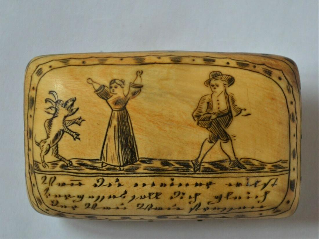 Bone Snuff Box: 19th Century German hand carved and scrimshawed bone snuff box. The box itself has a hinged lid that still closes nicely. The decoration features a man and woman and a dog that appears to be pleading 