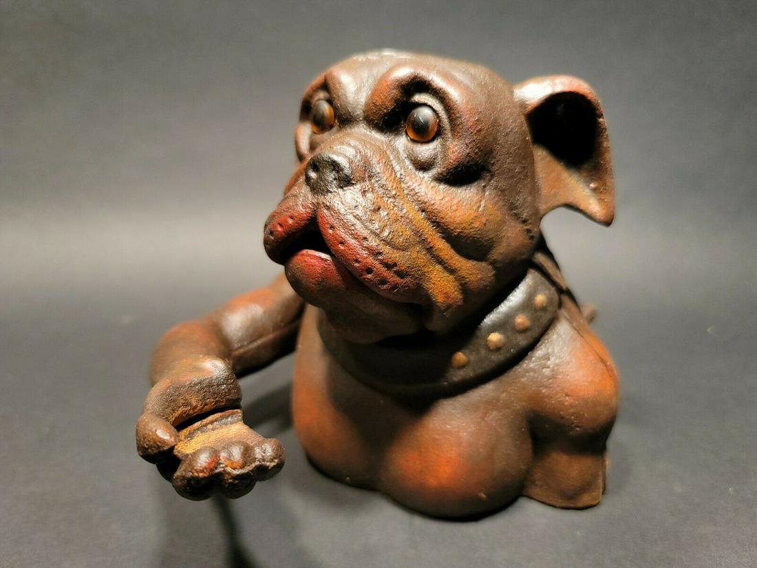 Cast Iron Bulldog Mechanical Dog Coin Bank John Harper: 7" Tall 6" Wide Great reproduction folk art cast iron mechanical coin bank. This piece was made to look just like an antique, but is actually new. By pressin the lever on the back the arm will lift an
