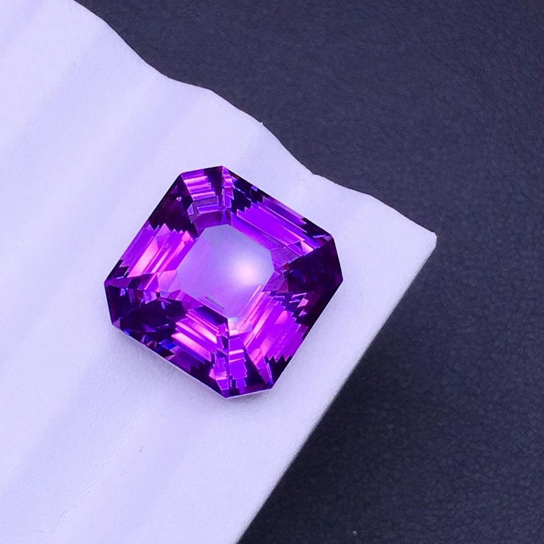Natural Ascher Cut 14.63 Carats Amethyst Loose Gemstone: Title: Natural Ascher Cut 14.63 Carats Amethyst Loose Gemstone Gemstones: Amethyst Carat Weights: 14.63 Size/Dimensions: 14.5*14.5*10 Additional Info: Treat:. Natural without treatment. Origin : Brazi