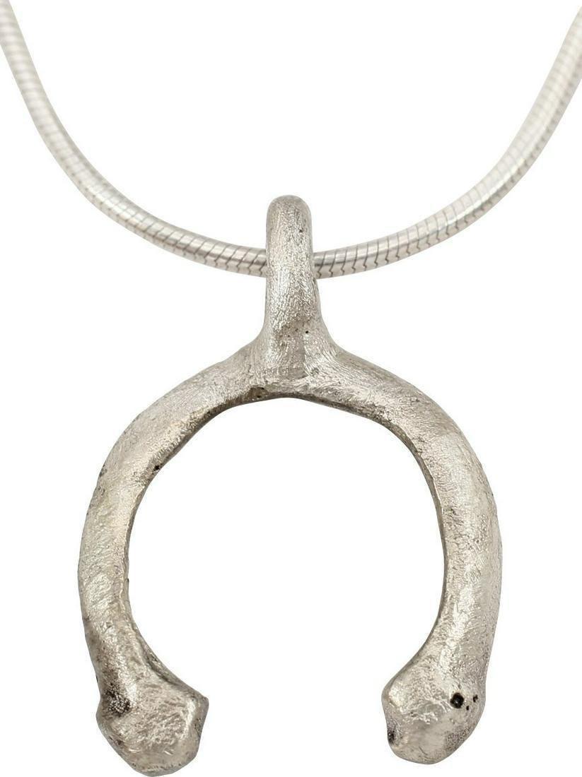 VIKING LUNAR PENDANT NECKLACE C.900-1000 AD JEWELRY: Just under 1" height including the suspension loop. Crescent form with expanded terminals representing Sol the sun and Mani the Moon. As expert navigators, the constellations signified mystery and pow