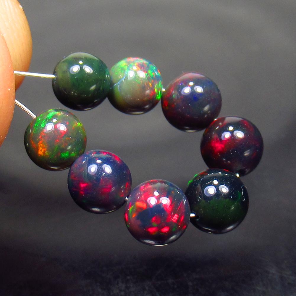 5.64 Ctw Natural 8 Drilled Black Fire Opal Ball Beads: No Reserve! Title: 5.64 Ctw Natural 8 Drilled Black Fire Opal Ball Beads Stone Clarity: Translucent Gemstone: Black Opal Beads Carat Weight: 5.64 Dimesnions: 5.20 to 5.50 mm / 8 PC's Additional Inform