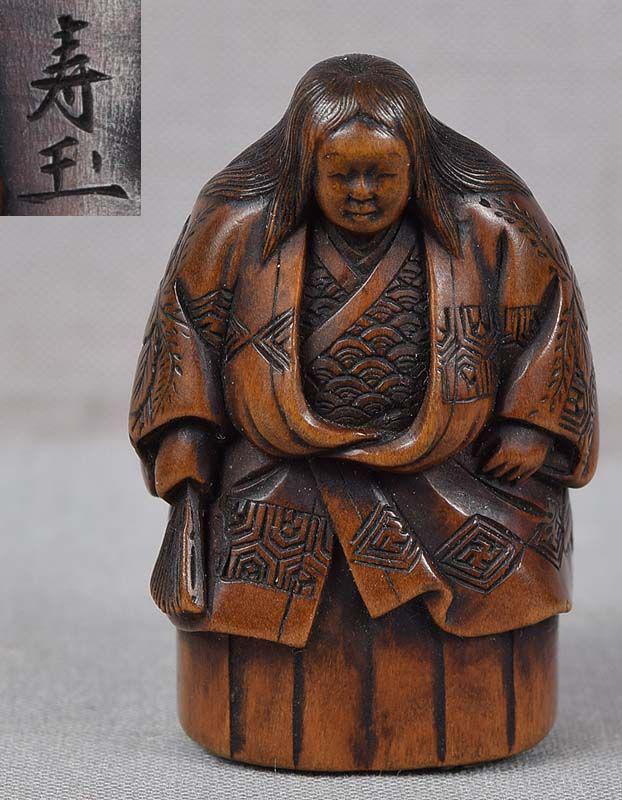 19c netsuke actor in SHOJO role by JUGYOKU: 19th century wooden netsuke of an actor in a role of shojo wearing richly decorated robe and typical shojo wig, and holding a folded fan in his hand. Shojo are mythical creatures living near the sea, 