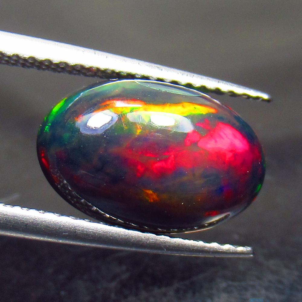 2.54 Ctw Natural Ethiopian Black Fire Opal Oval Cab: No Reserve! Title: 2.54 Ctw Natural Ethiopian Black Fire Opal Oval Cab Stone Clarity: Opaque Gemstones: Black Opal Carat Weights: 2.54 Size/Dimensions: 12.80 x 7.90 x 4.80 mm Additional Information: E