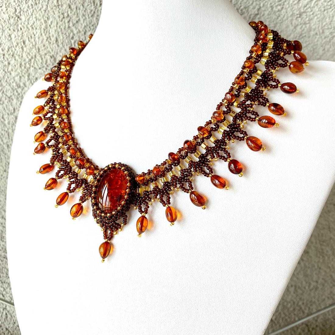 Unique and Splendid Amber Floral Necklace made from: Title: Unique and Splendid Amber Floral Necklace made from leaf like bead ornaments Metal: None Gemstones: Amber Weight: 44.0 g Size: Size: 60.0 x 10.0 x 440.0 mm Size: 2.362 x 0.394 x 17.323 inches M