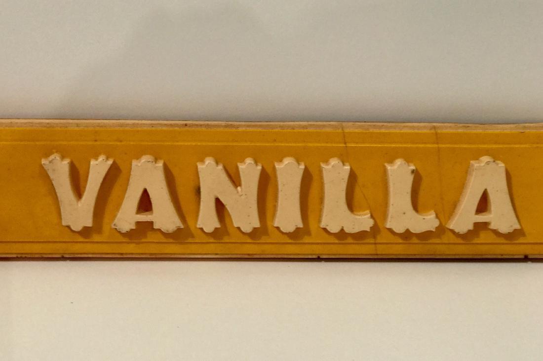 Vanilla Sign: Item: Ice cream parlor sign on bakelite-like material with graphic applied letters & shaped linen fold corners Date: c. 1920 Dimensions: 3 h x 27 w Shipping: Domestic: Flat-rate of $55.00 to anywhere