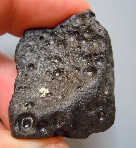 PHILIPPINITE TEKTITE - FROM METEORITE IMPACT: Title: PHILIPPINITE TEKTITE - FROM METEORITE IMPACT Origin: Paracale, Camarines Norte, Luzon, Philippines Size: 2.5x2.5x1 cm / 13 gram Description: square shaped flat and pitted rizalite/philippinite