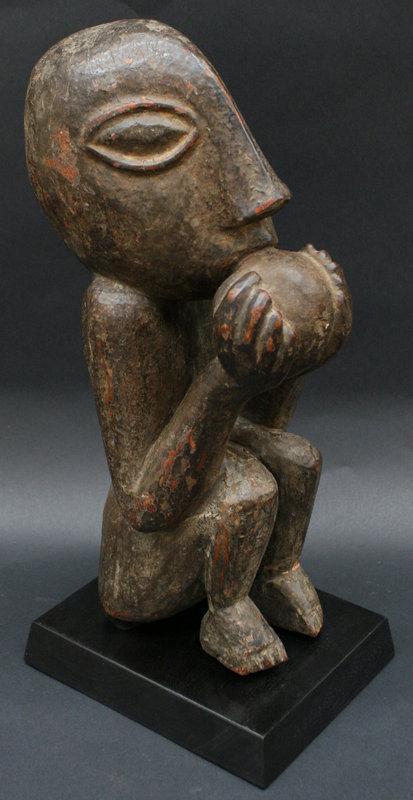 Nepalese Temple Sculpture of a Monkey Eating a Mango: Nepalese Sculpture of a Monkey Eating a Mango. These monkeys would be situated on bridges to guard the bridge and protect the people crossing it. From the collection of Sam Hilu, prominent collector a