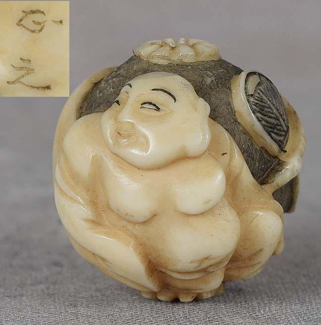 19c OJIME netsuke slide HOTEI by MASAYUKI: 19th century ojime (slide bead for tightening the cord going from netsuke to inro) in ball form carved in the round with the figure of Hotei with his fan and staff, seated leaning on his huge bag of g