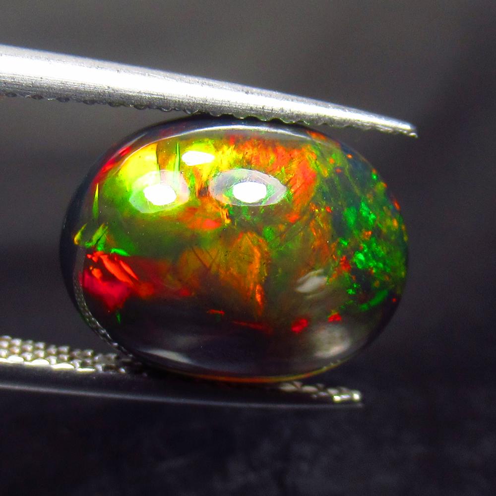 3.54 Ctw Natural Ethiopian Black Fire Opal Oval Cab: No Reserve! Title: 3.54 Ctw Natural Ethiopian Black Fire Opal Oval Cab Stone Clarity: Opaque Gemstones: Black Opal Carat Weights: 3.54 Size/Dimensions: 12.30 x 9.70 x 6.30 mm Additional Information: E