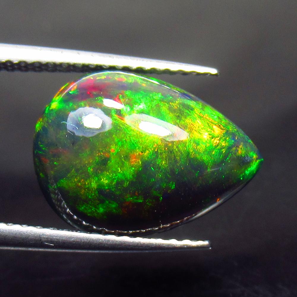 3.46 Ctw Natural Ethiopian Black Fire Opal Pear Cab: No Reserve! Title: 3.46 Ctw Natural Ethiopian Black Fire Opal Pear Cab Stone Clarity: Opaque Gemstones: Black Opal Carat Weights: 3.46 Size/Dimensions: 14.10 x 10.60 x 5.70 mm Additional Information: 